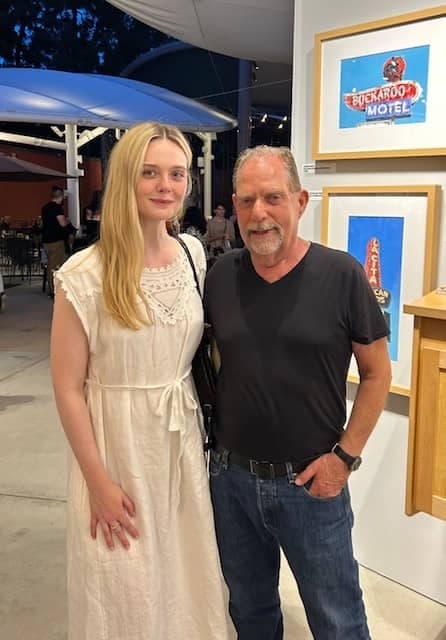 David Milton with actress Elle Fanning at art show